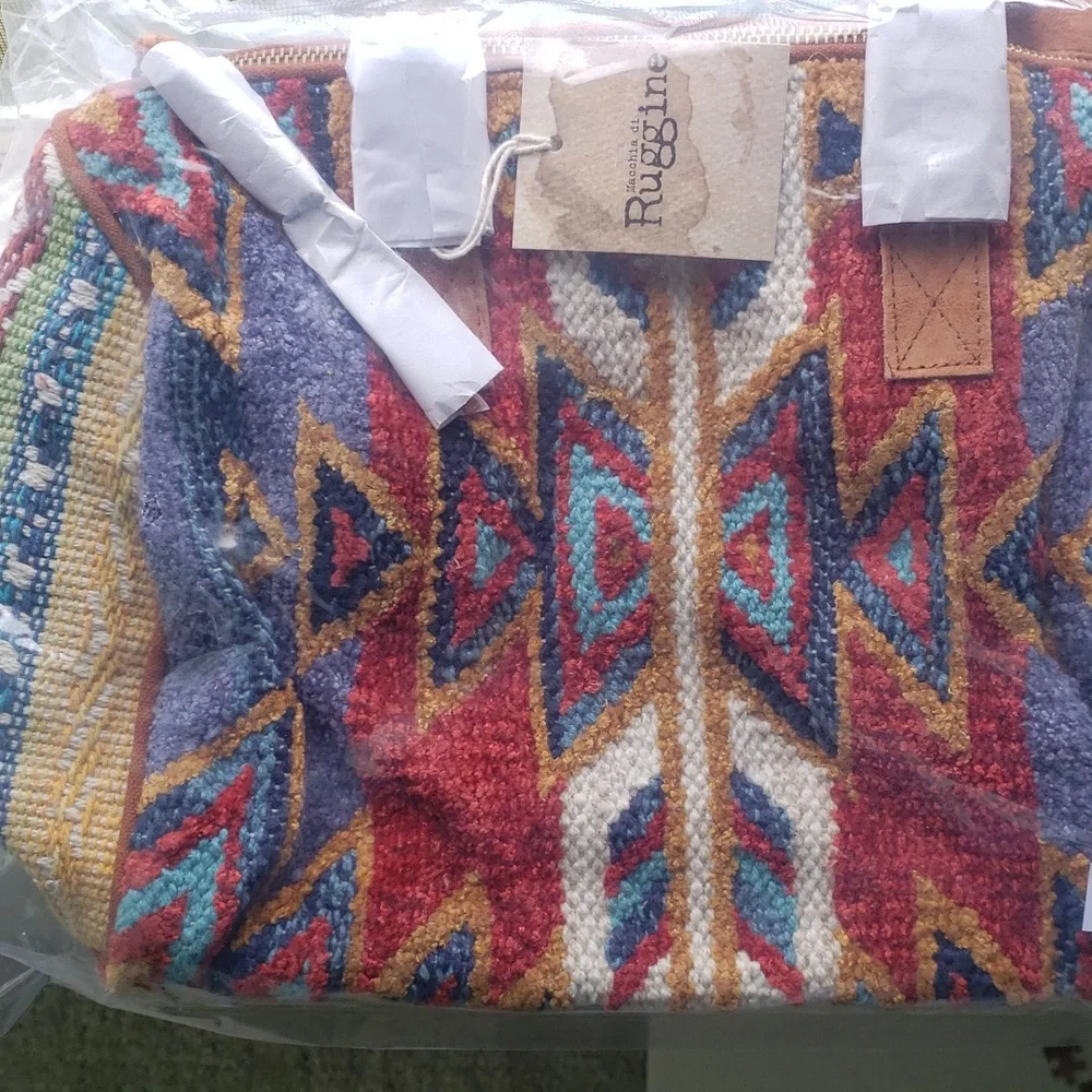 Beautiful woven Winthrop Boston Bagwith genuine suede handle and tassel detail.